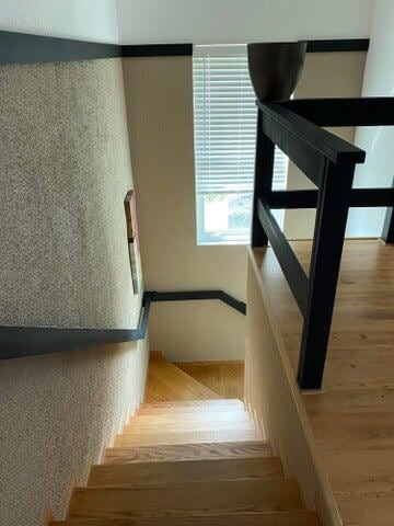 stairs featuring hardwood / wood-style floors