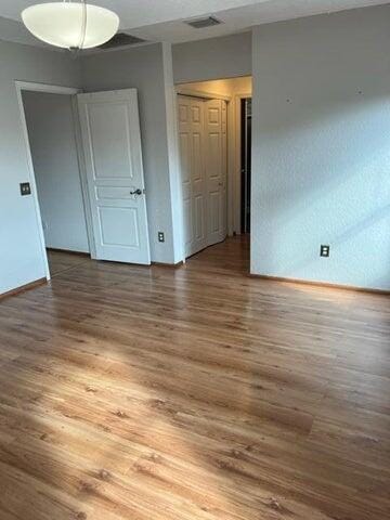 spare room featuring wood-type flooring