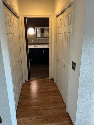 hallway with dark wood-type flooring