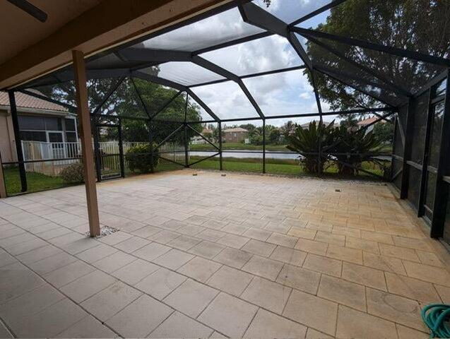 view of patio / terrace featuring glass enclosure