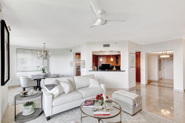 living room featuring ceiling fan with notable chandelier