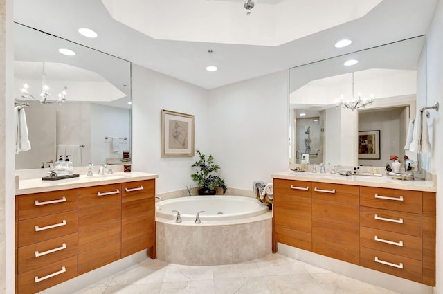 bathroom with vanity, a chandelier, and independent shower and bath