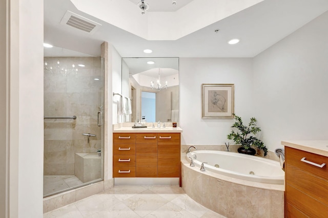 bathroom with independent shower and bath, vanity, and an inviting chandelier