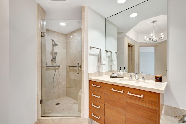 bathroom with tile patterned flooring, a chandelier, vanity, and an enclosed shower