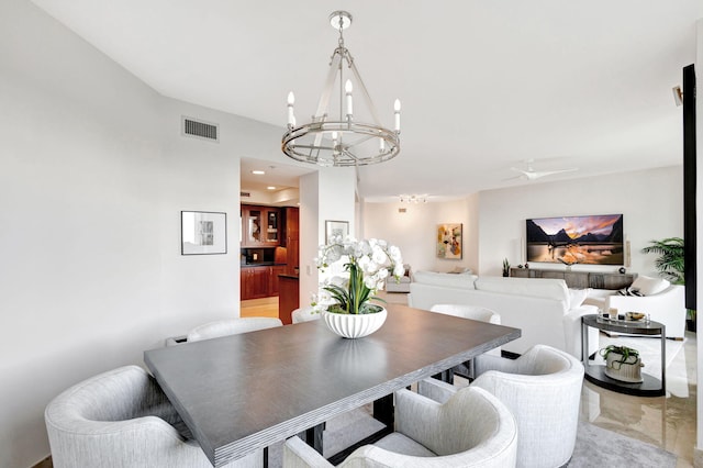 dining room featuring ceiling fan with notable chandelier