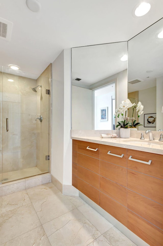 bathroom featuring walk in shower and vanity