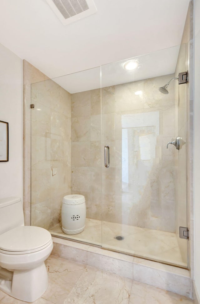 bathroom featuring toilet and an enclosed shower