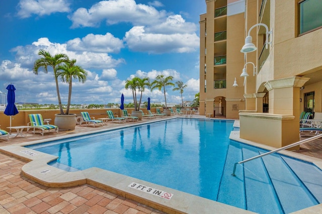 view of swimming pool featuring a patio area