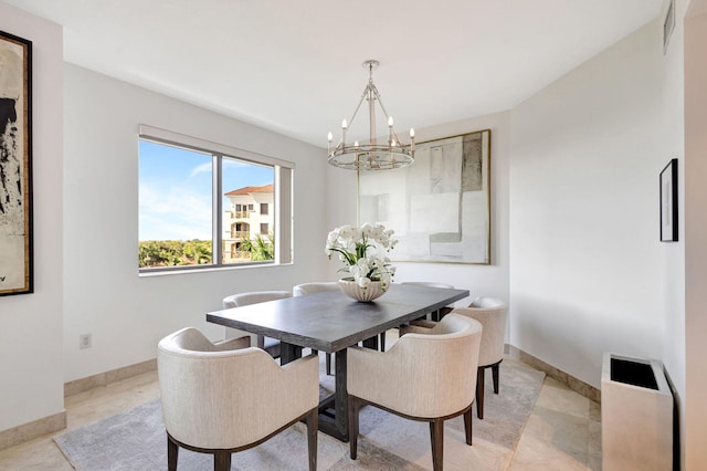 dining room featuring light tile patterned flooring and an inviting chandelier