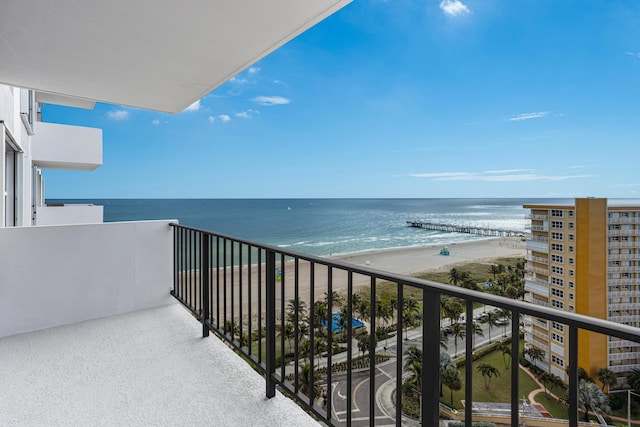 balcony featuring a beach view and a water view