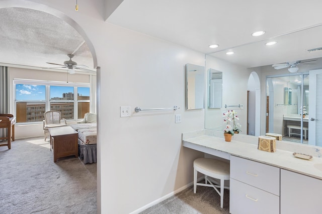 bathroom featuring ceiling fan and a textured ceiling