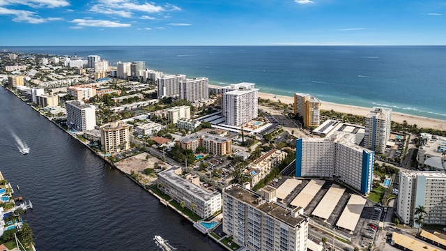 bird's eye view featuring a water view and a beach view