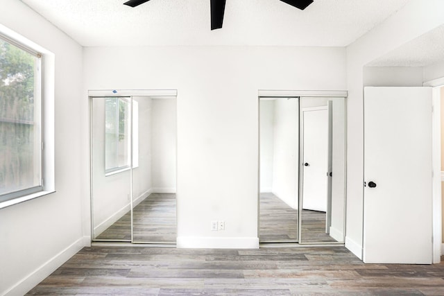 unfurnished bedroom featuring a textured ceiling, wood-type flooring, and ceiling fan