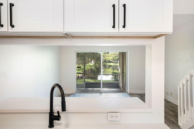 details featuring white cabinets and hardwood / wood-style flooring