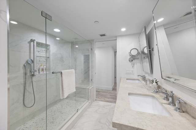 bathroom with vanity, a shower with shower door, and hardwood / wood-style flooring