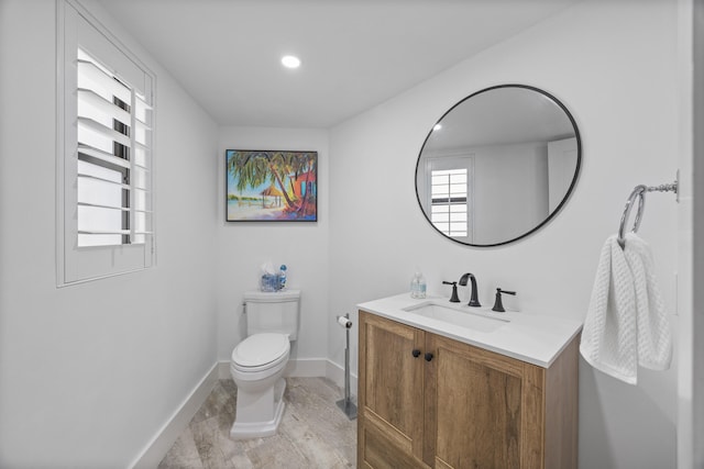 bathroom featuring vanity, hardwood / wood-style floors, and toilet