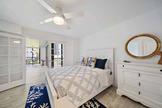 bedroom with ceiling fan, light wood-type flooring, and vaulted ceiling