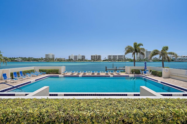 view of pool featuring a water view and a patio area