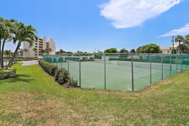 view of sport court with a lawn