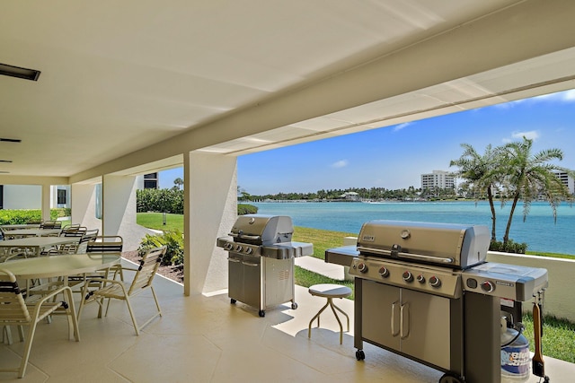 view of patio / terrace featuring a grill and a water view