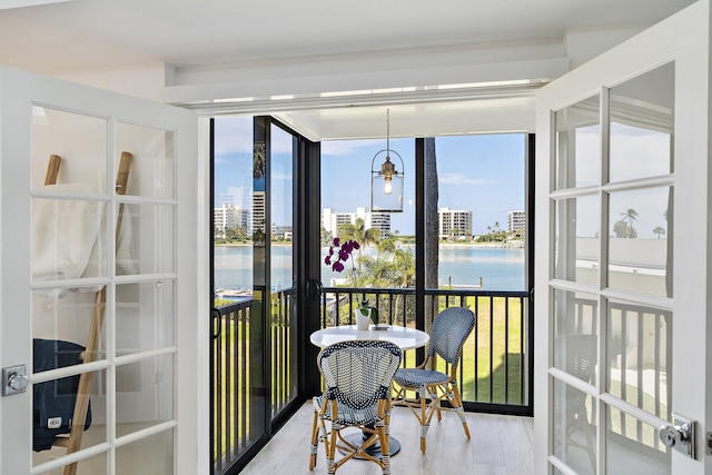 sunroom / solarium featuring a water view