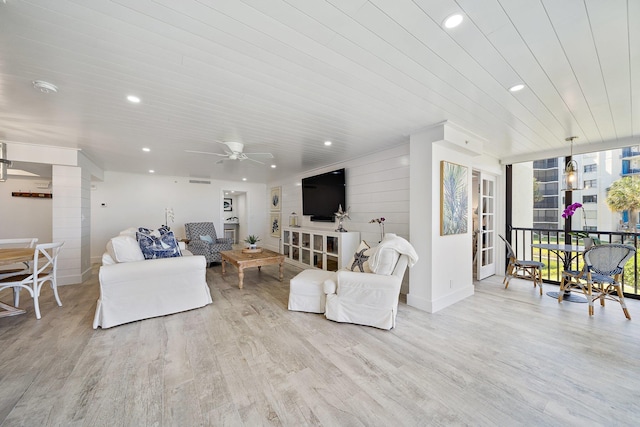 living room featuring light hardwood / wood-style floors and ceiling fan