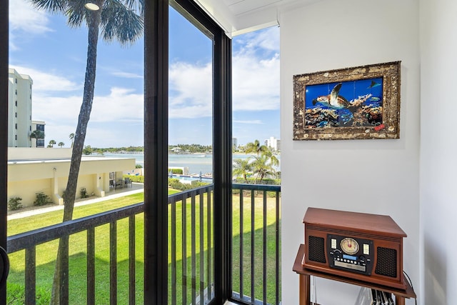 sunroom / solarium with a water view