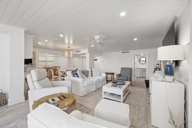 living room featuring ceiling fan with notable chandelier, light hardwood / wood-style floors, and wooden ceiling