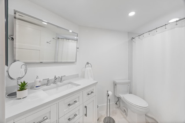 bathroom featuring curtained shower, vanity, and toilet