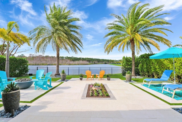 view of patio / terrace with a water view and an outdoor fire pit