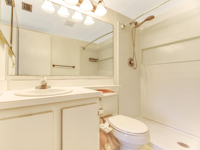 bathroom with walk in shower, vanity, and toilet