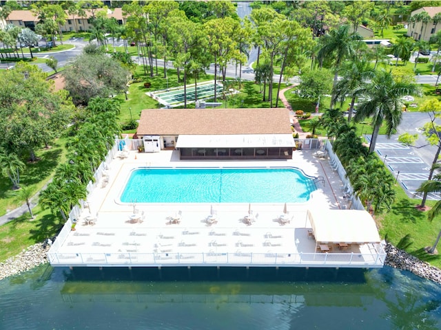 view of pool with a patio and a water view