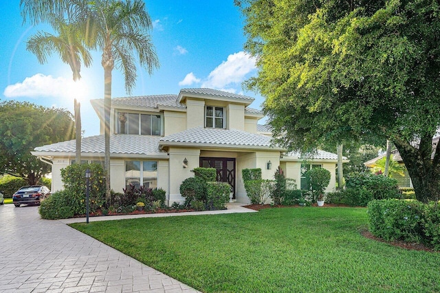 mediterranean / spanish-style home featuring a front yard