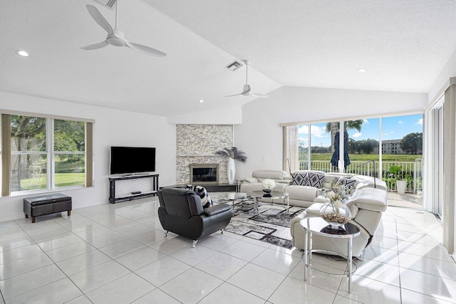 living room with a textured ceiling, light tile patterned floors, lofted ceiling, and a fireplace