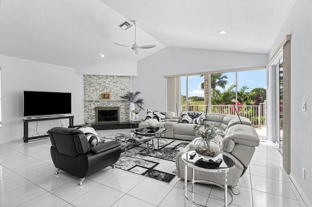 tiled living room with a fireplace, vaulted ceiling, and ceiling fan