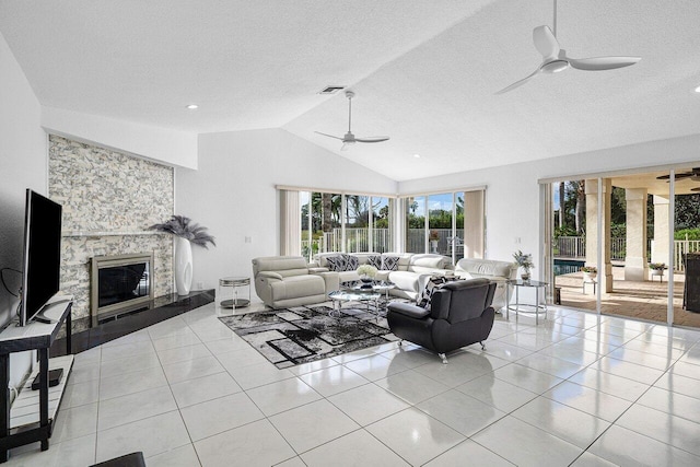 tiled living room featuring a textured ceiling, vaulted ceiling, and ceiling fan