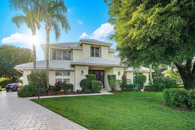 mediterranean / spanish-style house with a front lawn