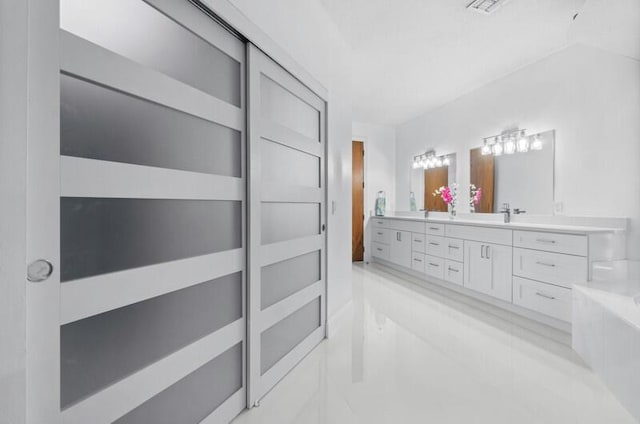 bathroom with vanity and a tub