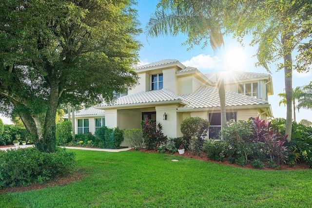 mediterranean / spanish home with a front lawn