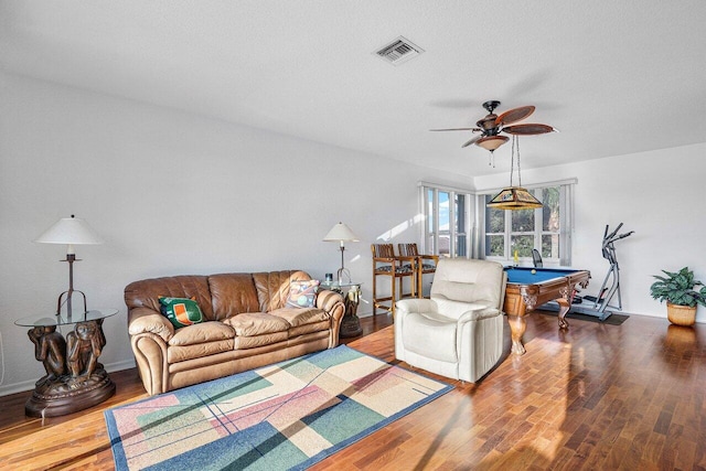 living room with wood-type flooring, a textured ceiling, ceiling fan, and billiards