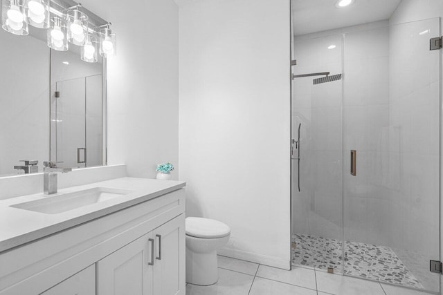 bathroom with tile patterned floors, vanity, toilet, and an enclosed shower