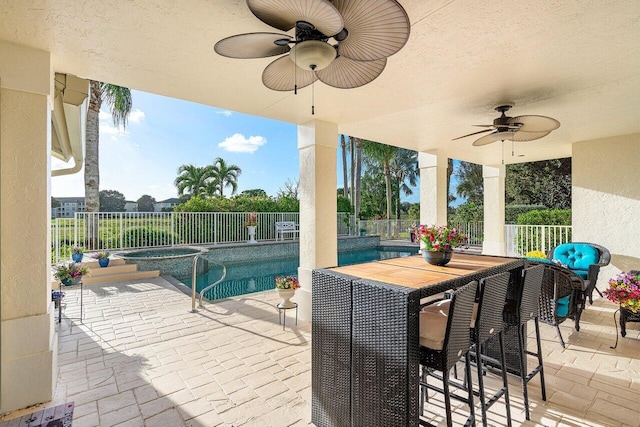 view of pool featuring an in ground hot tub, a patio area, and ceiling fan