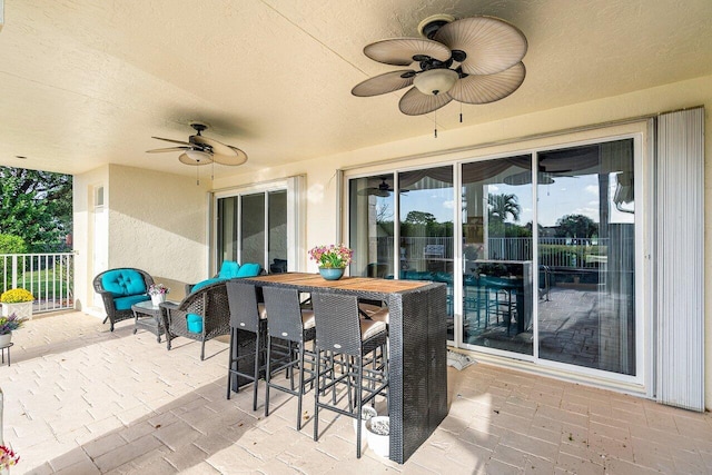 view of patio featuring ceiling fan