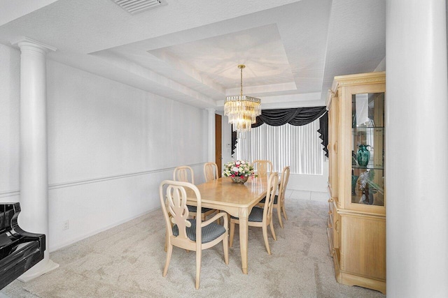 dining space featuring light colored carpet, a raised ceiling, and an inviting chandelier