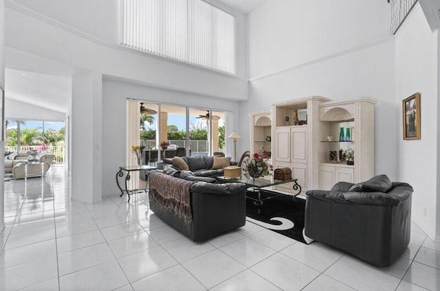 living room featuring light tile patterned floors, a wealth of natural light, and a high ceiling