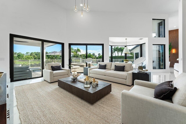 living room featuring a towering ceiling and light tile patterned flooring