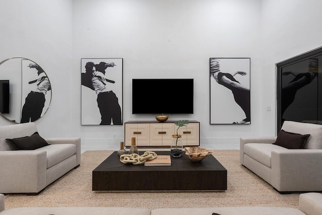 living room with a towering ceiling and light tile patterned floors