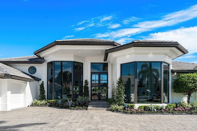 view of front of property with french doors and a garage