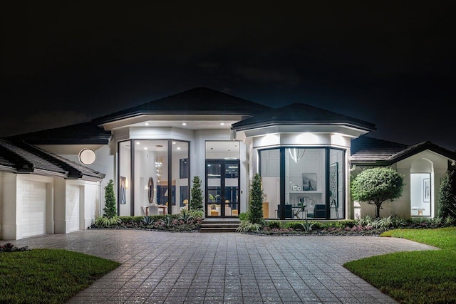 view of front of property with a garage and french doors