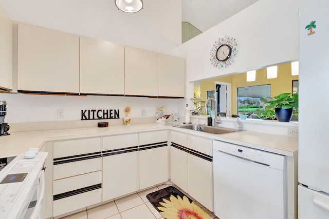 kitchen featuring white cabinets, sink, light tile patterned floors, high vaulted ceiling, and white appliances